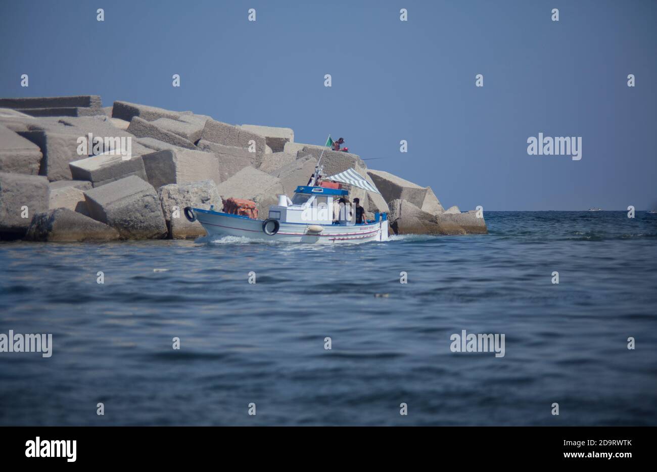 Fishing boat returns to the port in Bagnera port in Sicly Stock Photo