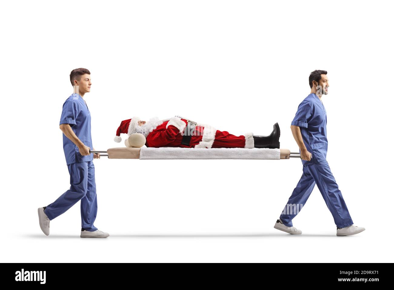 Two male health workers carrying Santa Claus on a stretcher  isolated on white background Stock Photo