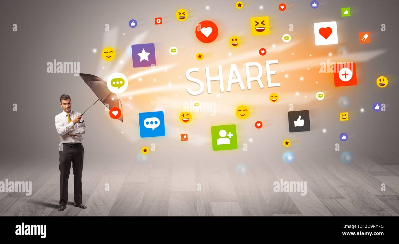 Handsome businessman defending with umbrella from SHARE inscription, social networking concept Stock Photo