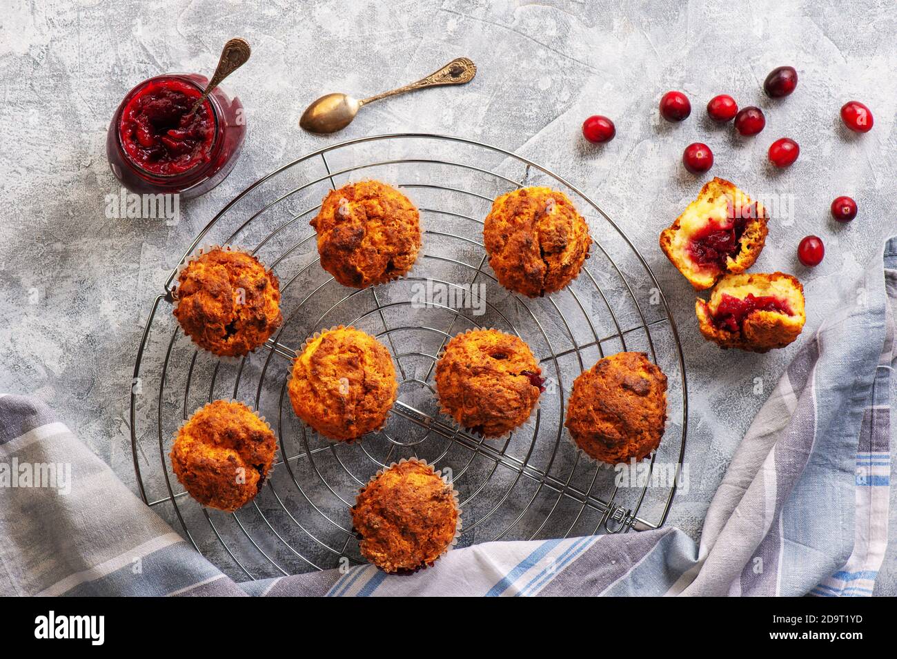 Homemade muffins with cranberry filling, on light background. Stock Photo
