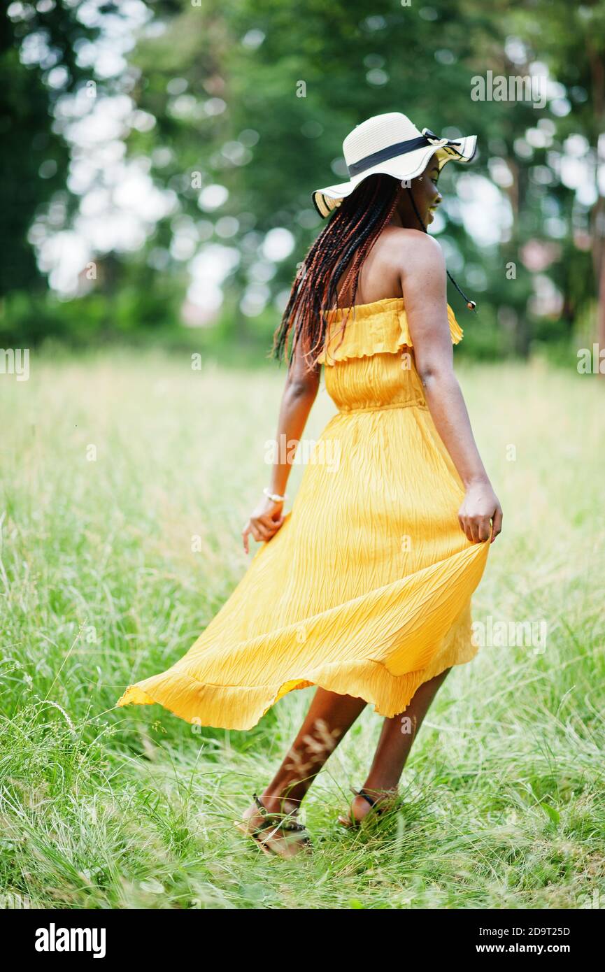 Portrait of gorgeous african american woman 20s in wear in yellow dress ...