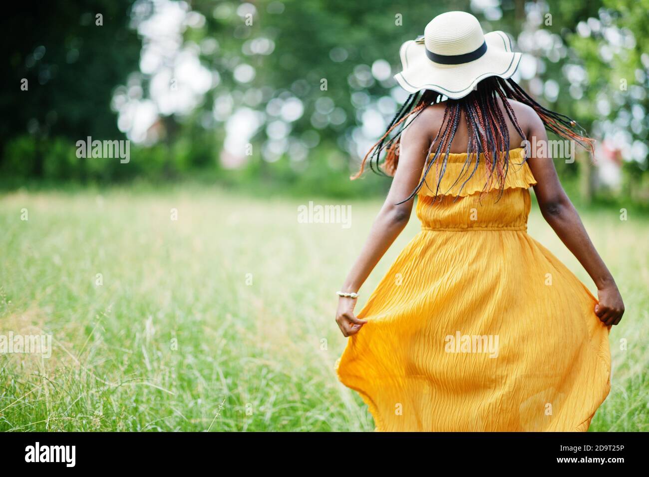 Portrait of gorgeous african american woman 20s in wear in yellow dress ...