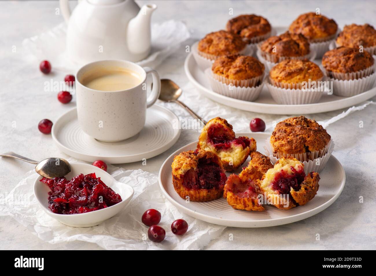 Homemade muffins with cranberry filling, on light background. Stock Photo