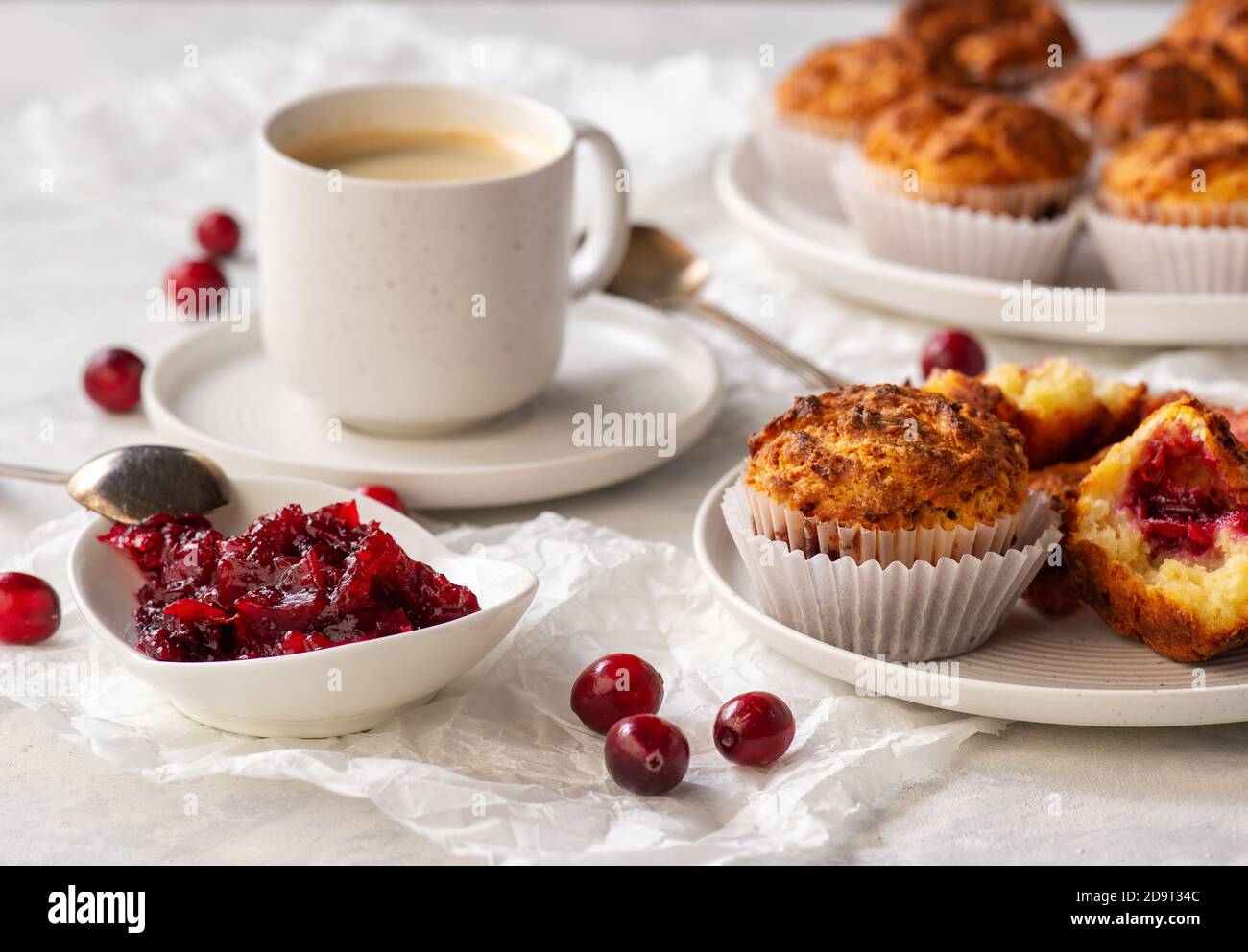 Homemade muffins with cranberry filling, on light background. Stock Photo
