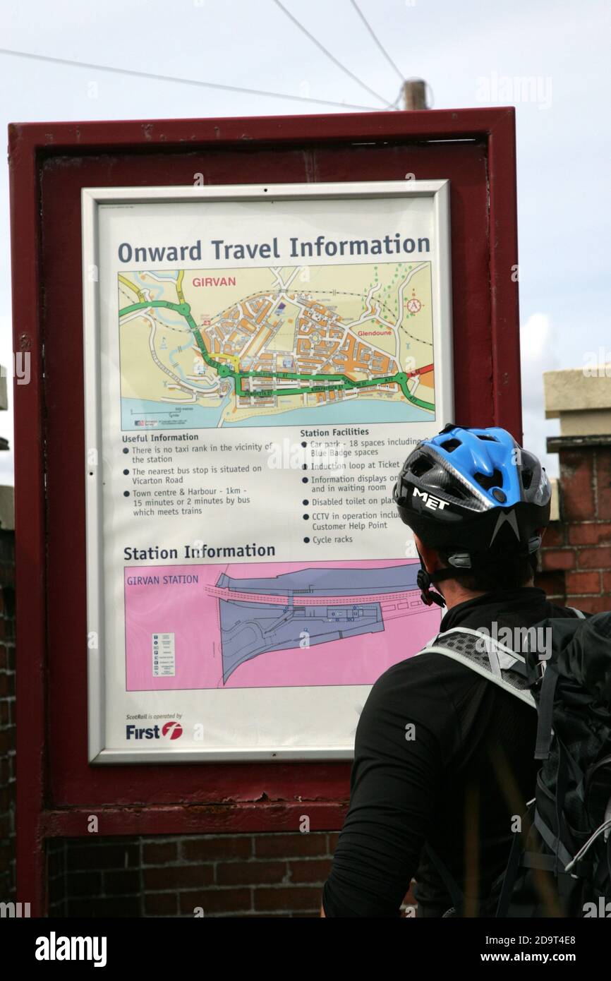 Girvan Railway Station, South Ayrshire, Scotland, UK. A cyclist wearing shorts and safety helmet arrives by train at Girvan Railway station before embarking on a bicylce ride Stock Photo