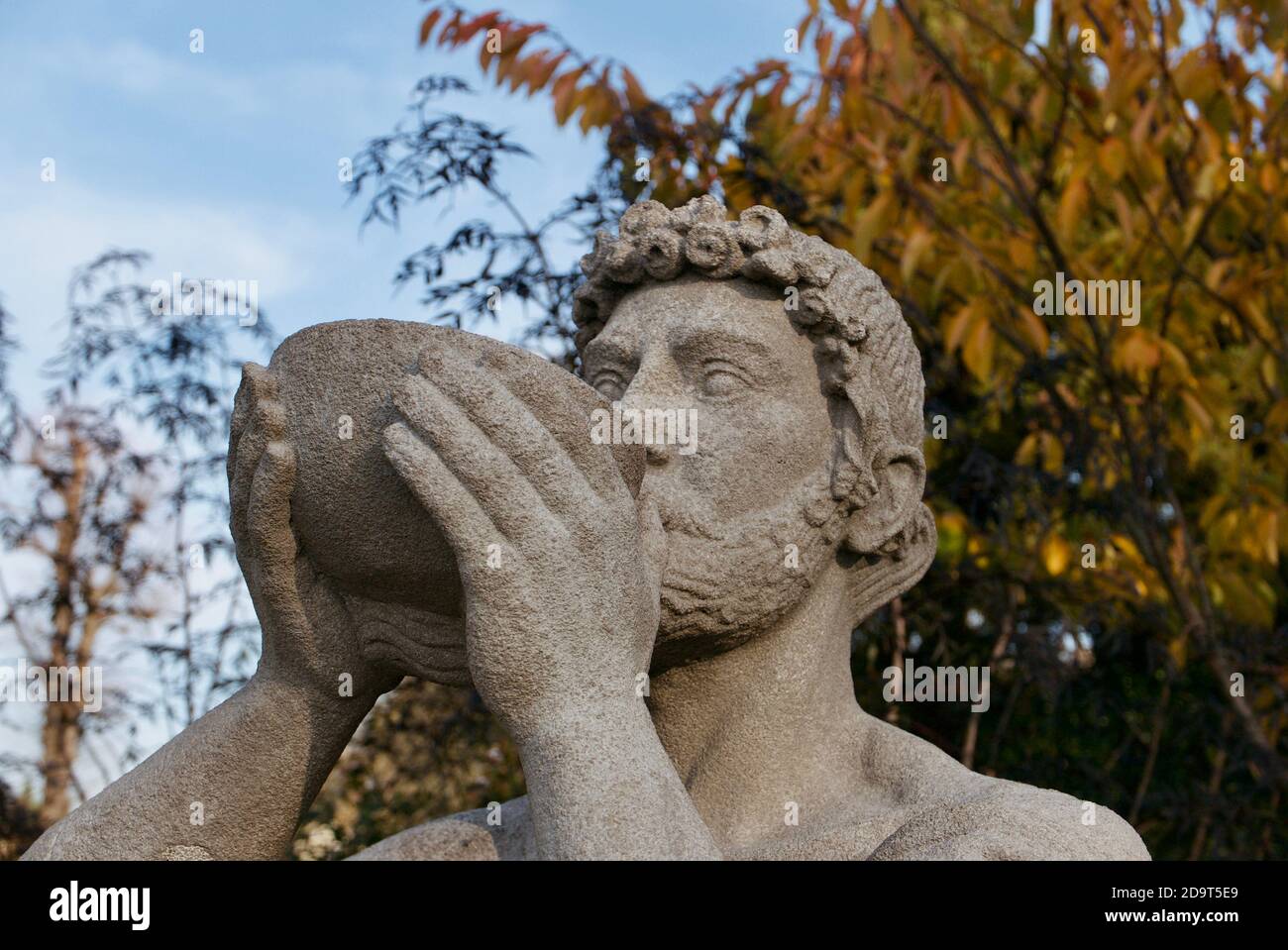 Diogenes drinking from a bowl sculpture from Greek mythology. Statue was created by artist Mark Batten. Located within Hampstead Heath, London. Stock Photo