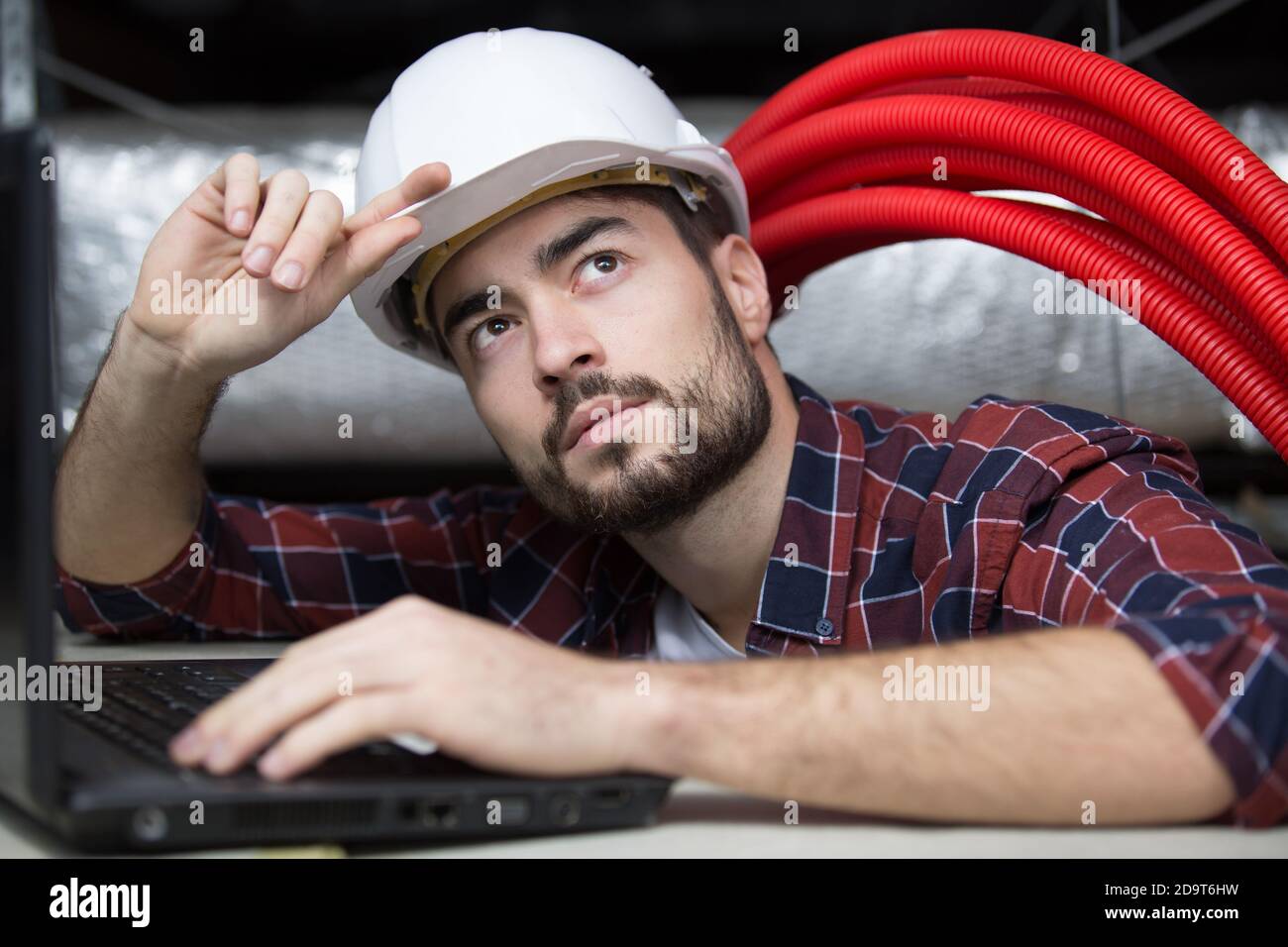 professional cctv technician working in the ceiling Stock Photo
