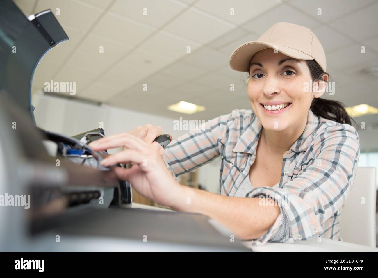 happy female fixing the printer Stock Photo