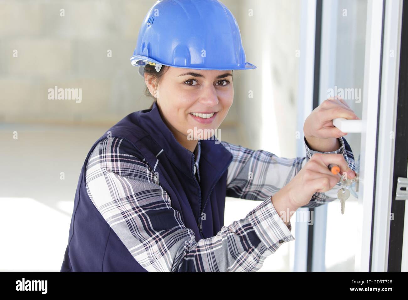 woman using a screw driver for installing door Stock Photo