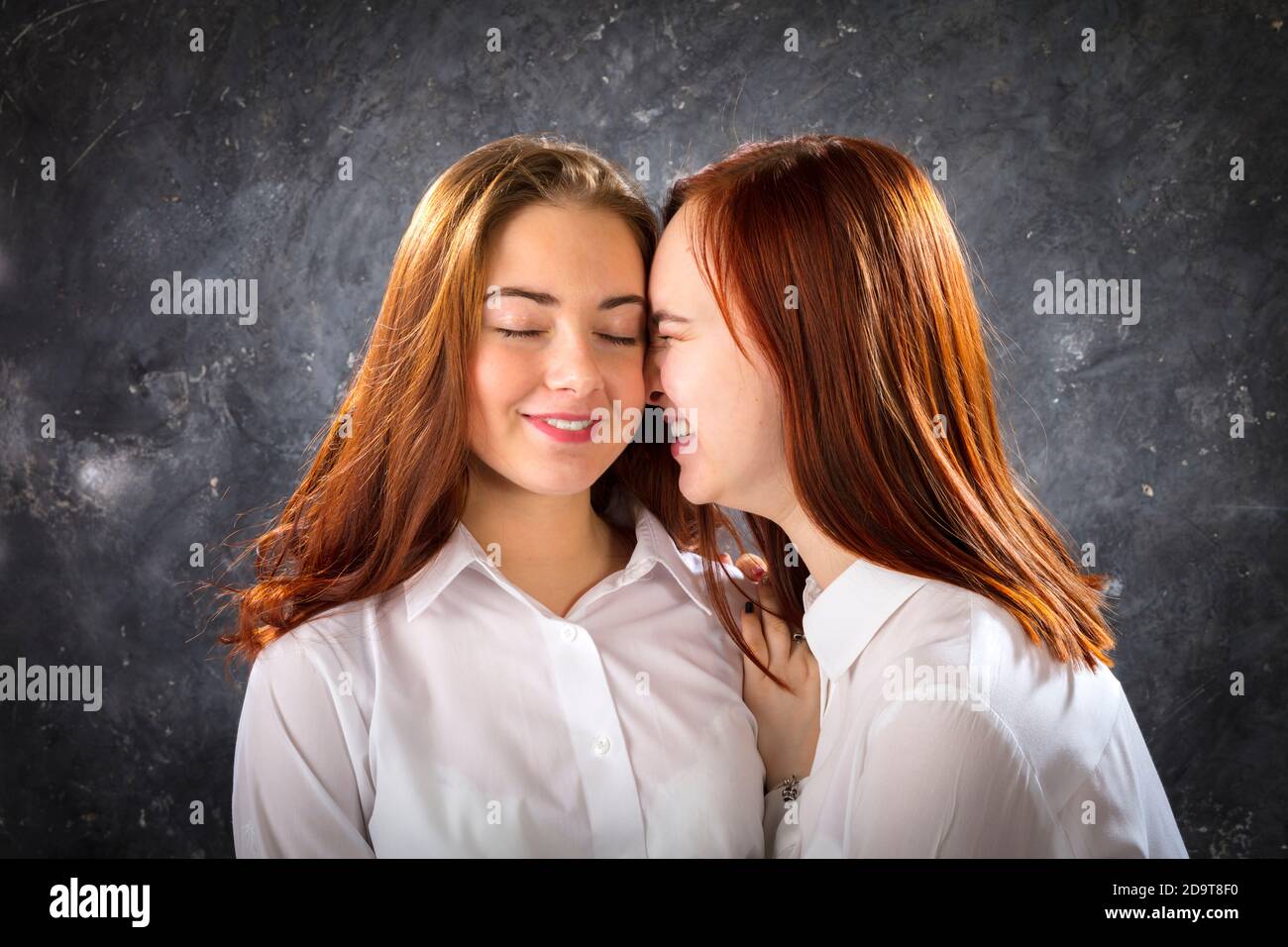 Two beautiful teen girls look happy studio portrait Stock Photo