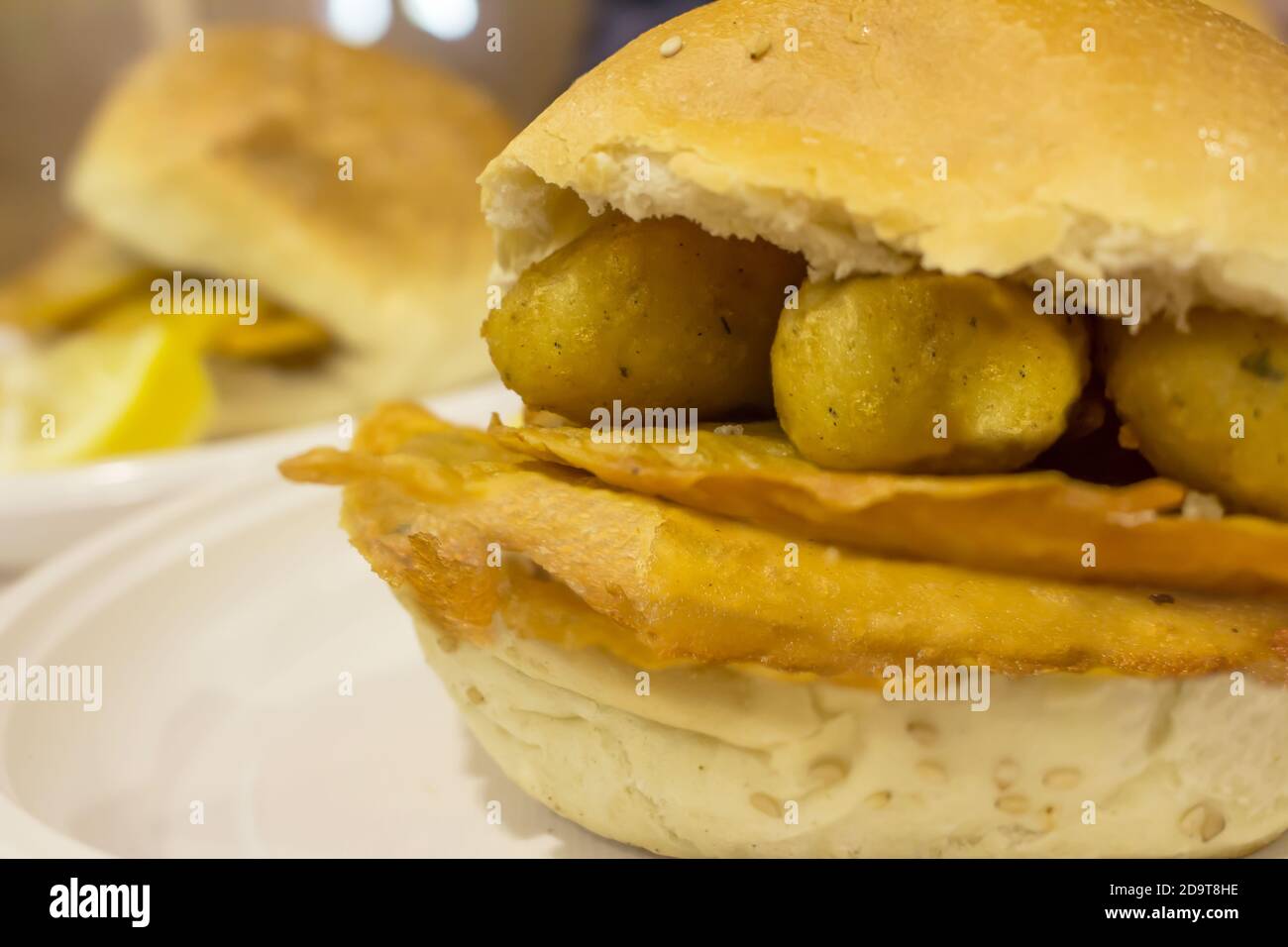 Sicilian street food sandwich with chickpea pancakes and potato