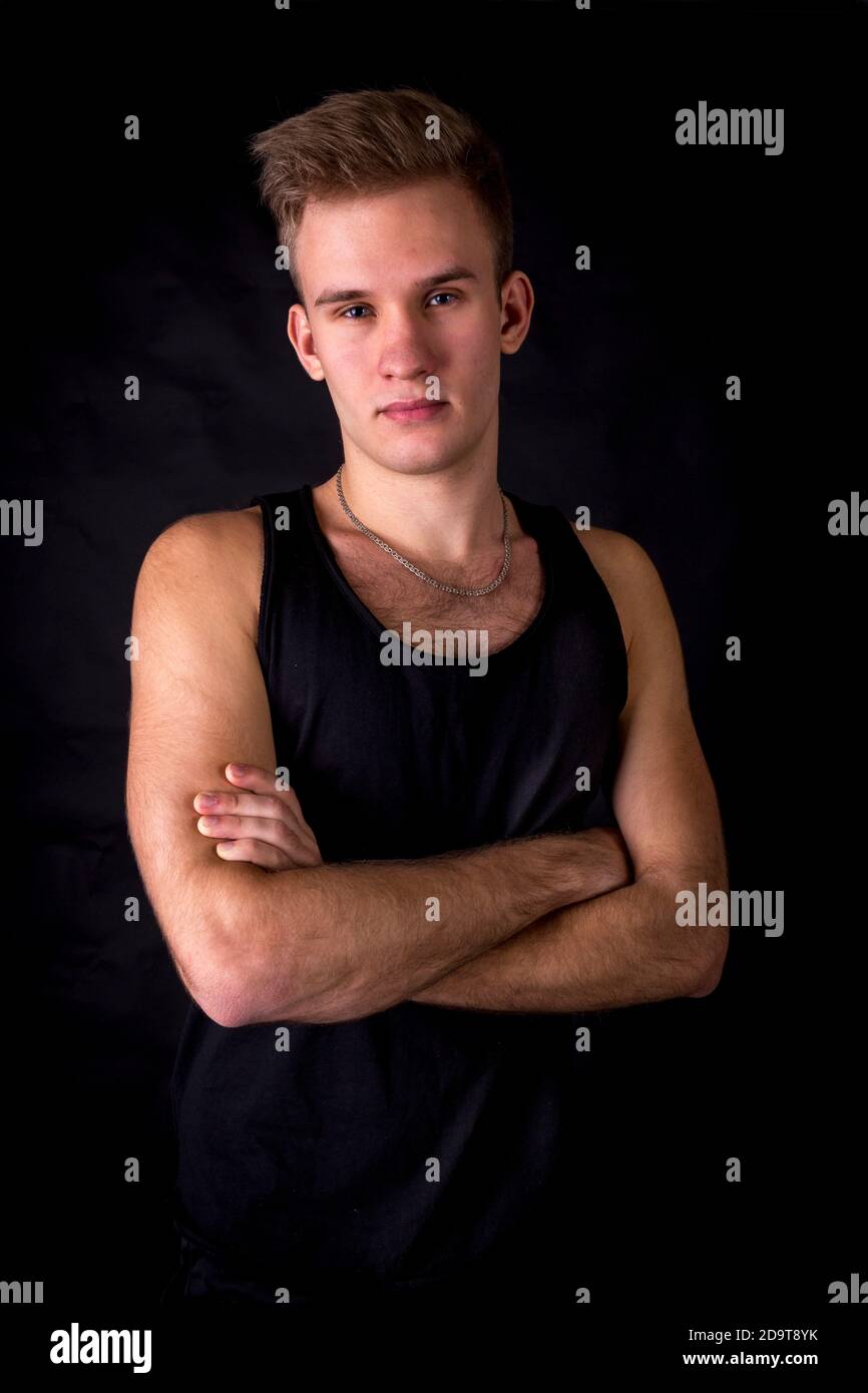 Young sportsman dressed in black vest studio portrait Stock Photo Alamy
