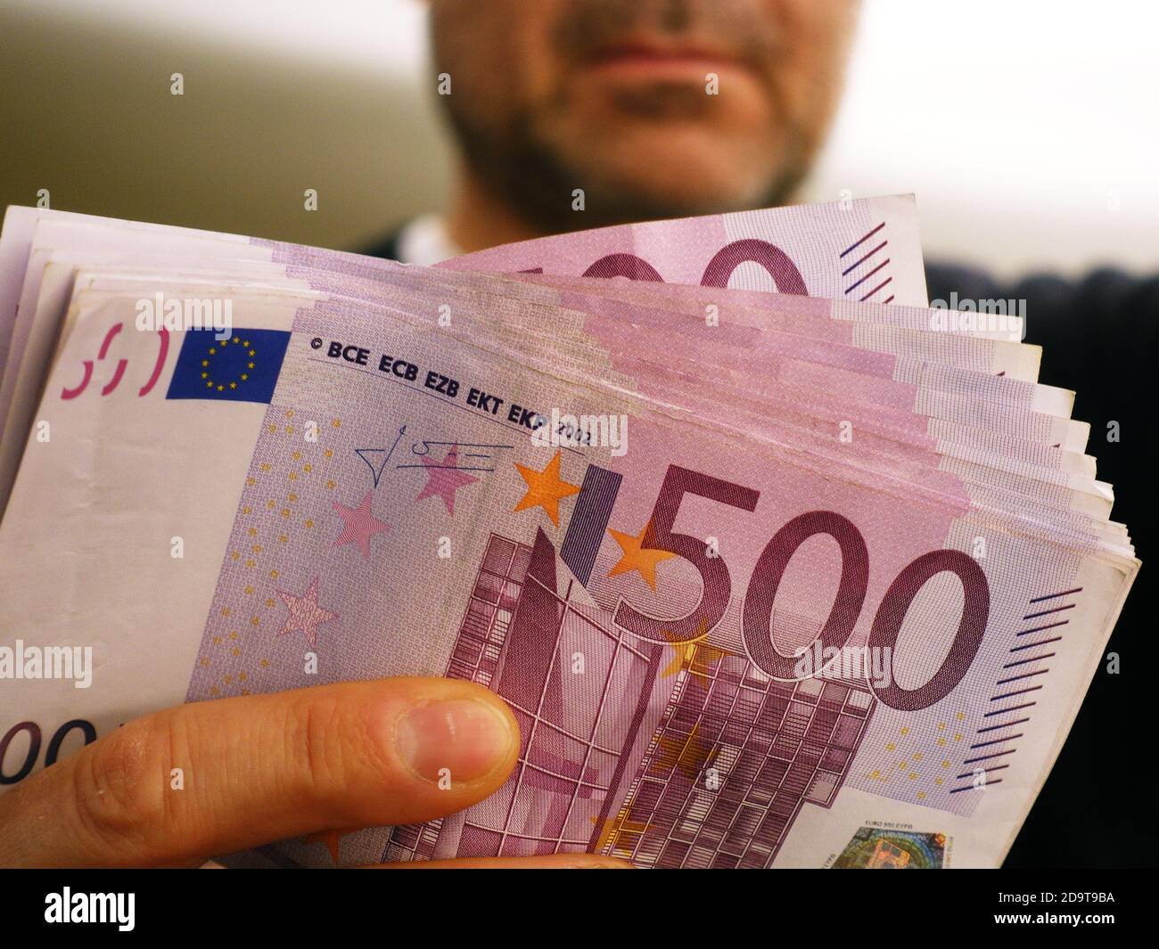 a rich man shows 10,000 euros in 500 euro notes Stock Photo
