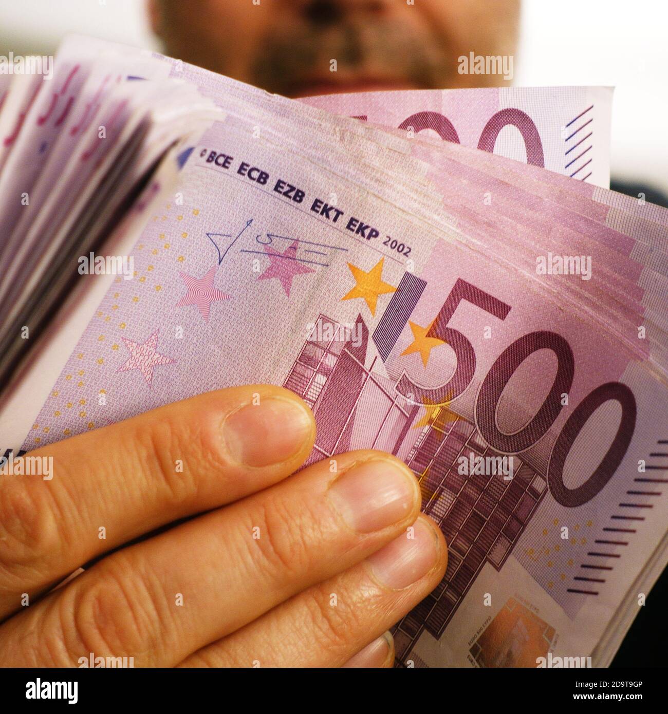 a rich man shows 10,000 euros in 500 euro notes Stock Photo