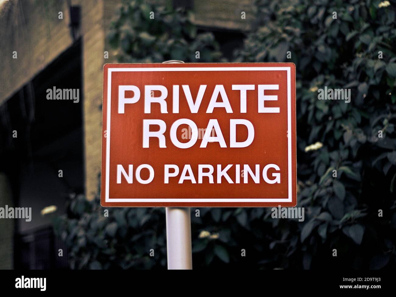 Private road, no parking sign. Not allowed. No thoroughfare. Clear red and white sign. Stock Photo