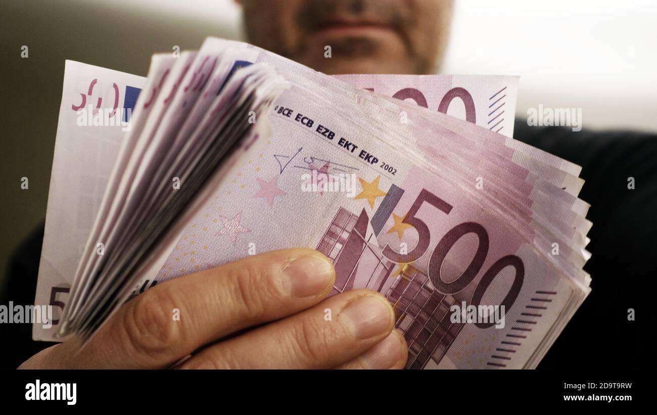 a rich man shows 10,000 euros in 500 euro notes Stock Photo