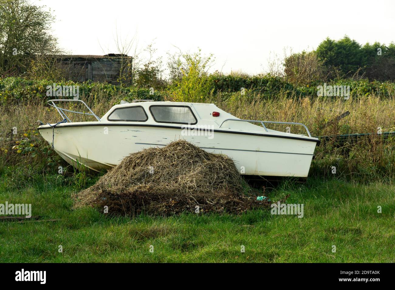 Small river boat on a dung heap Stock Photo Alamy