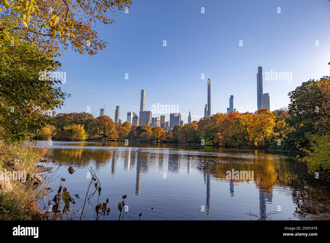 Trees and buildings reflect off the Lake in Central Park, New York City