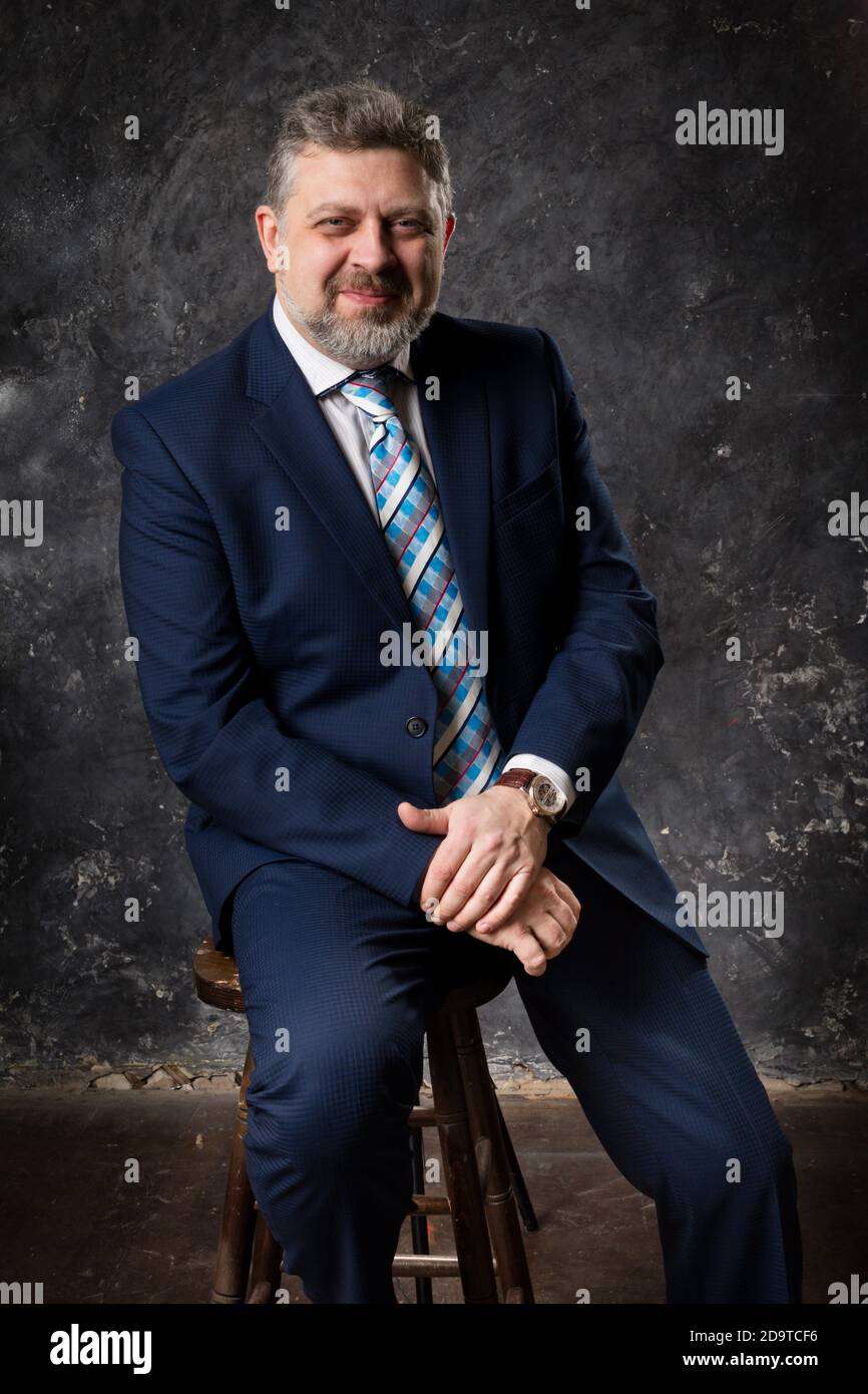 Mature businessman in a suit studio portrait Stock Photo - Alamy