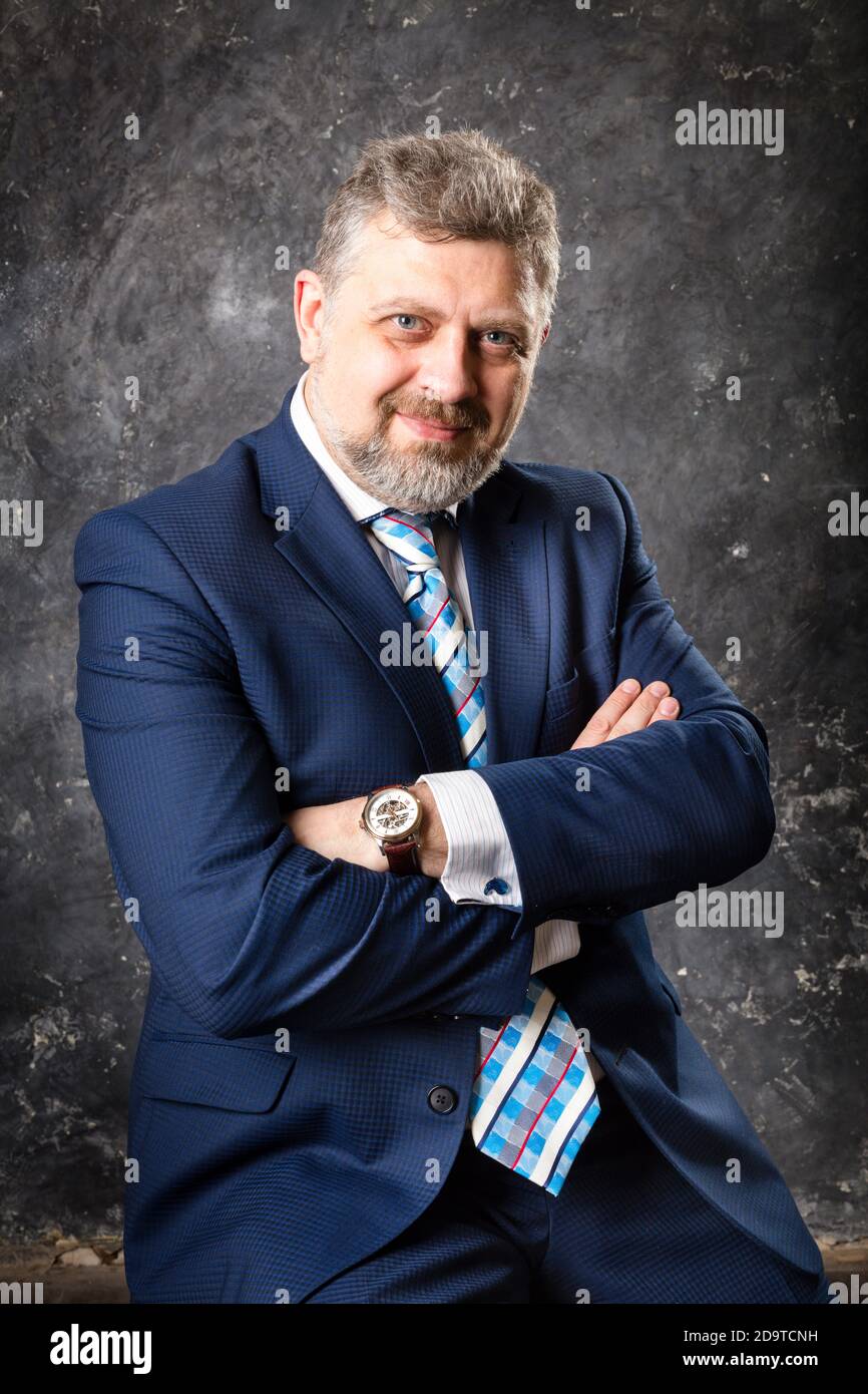 Mature businessman in a suit studio portrait Stock Photo - Alamy