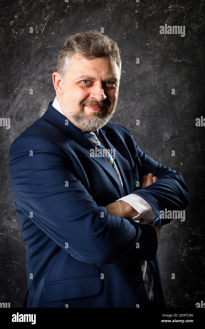 Mature businessman in a suit studio portrait Stock Photo - Alamy