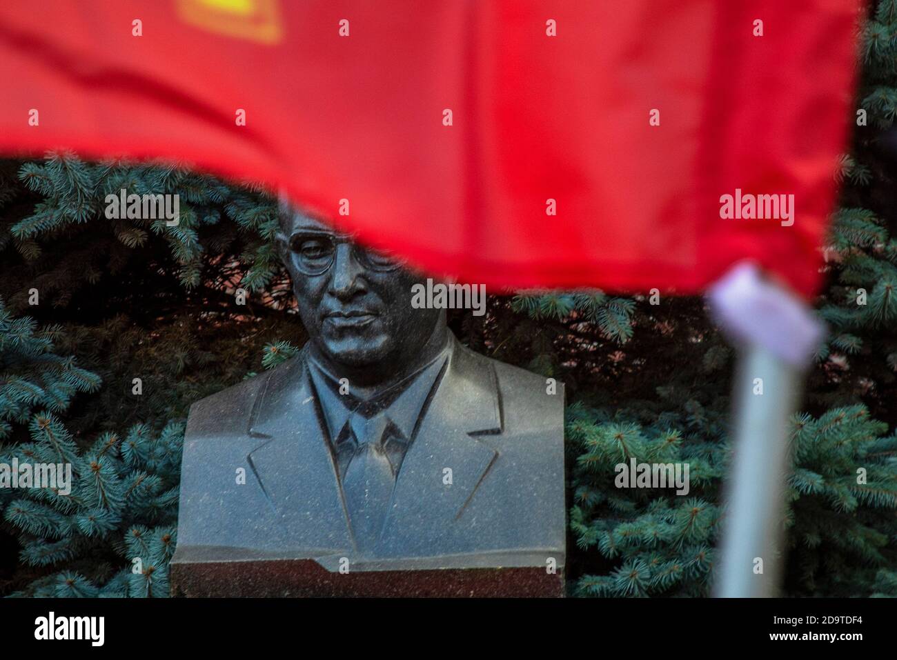 Bust of the Soviet Union leader Yuri Andropov in the background of a Pine Tree at the Kremlin Wall Necropolis on Red Square in the center of Moscow, Russia Stock Photo