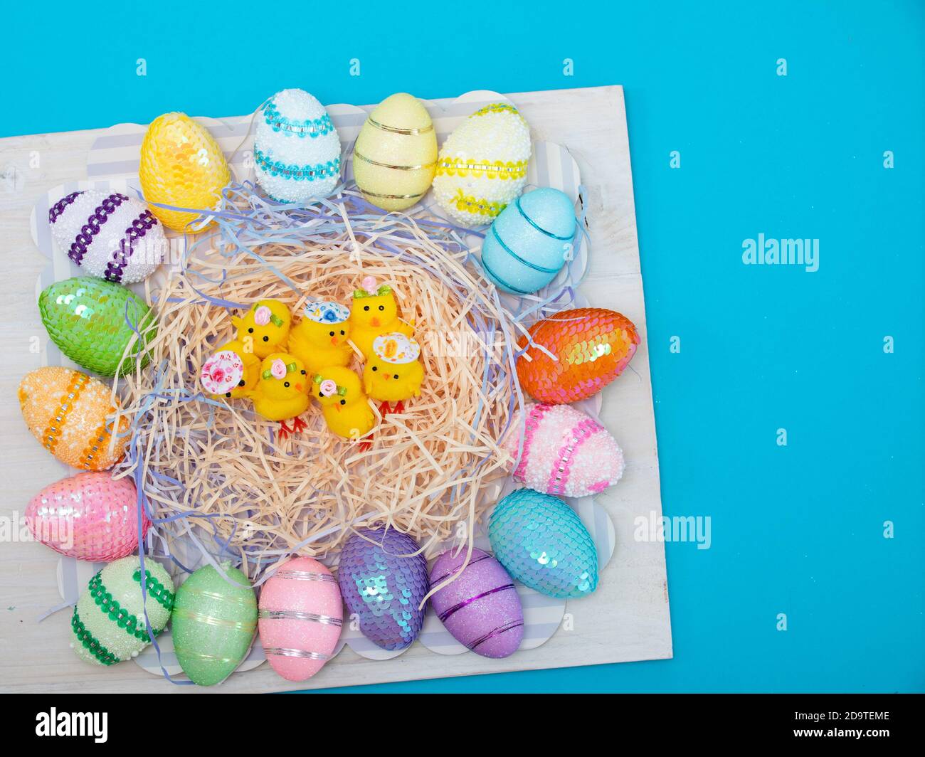 Easter eggs and chiks on blue background. Stock Photo