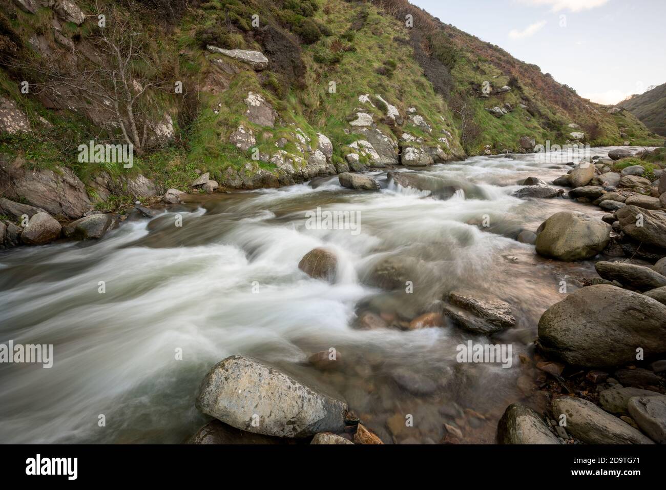 Long exposure of the river Heddon flowing through the Heddon valley at Heddons Mouth in Exmoor Stock Photo