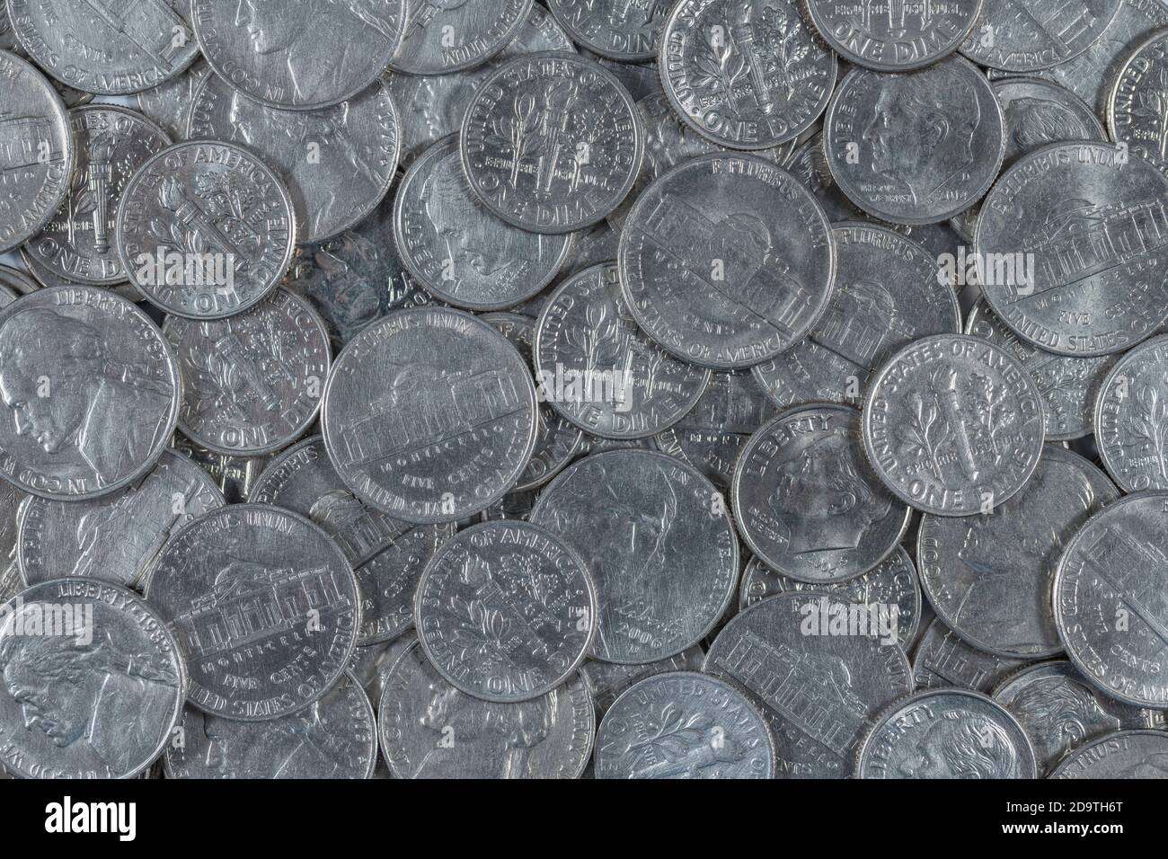 Close shot mass of U.S. nickels and dimes coins. For cheap, low-paying job, low-cost, penny-pinch, five and dime store, being frugal, coin shortage. Stock Photo