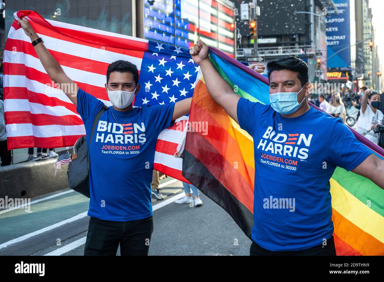 New York, USA. 7th Nov, 2020. People wear face masks as they celebrate in New York City's Times Square after news broke out that former vice-president Joe Biden won the US presidential elections. Biden defeated President Donald Trump to become the 46th president of the United States and Kamala Harris will be the first female vice-president. Credit: Enrique Shore/Alamy Live News Stock Photo