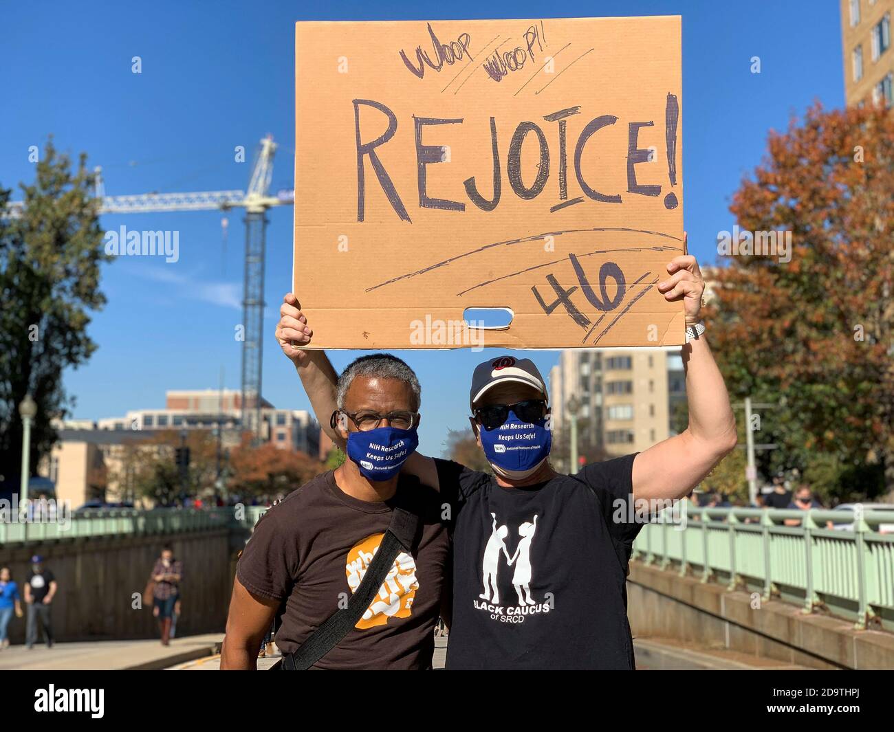 Washington, District of Columbia, USA. 7th Nov, 2020. Daryl Anderson and Jerry Overman walk towards the celebration in Black Lives Matter Plaza following the announcement that the Biden-Harris ticket won the election. They have one simple word: 'RejoiceÃ Credit: Sue Dorfman/ZUMA Wire/Alamy Live News Stock Photo