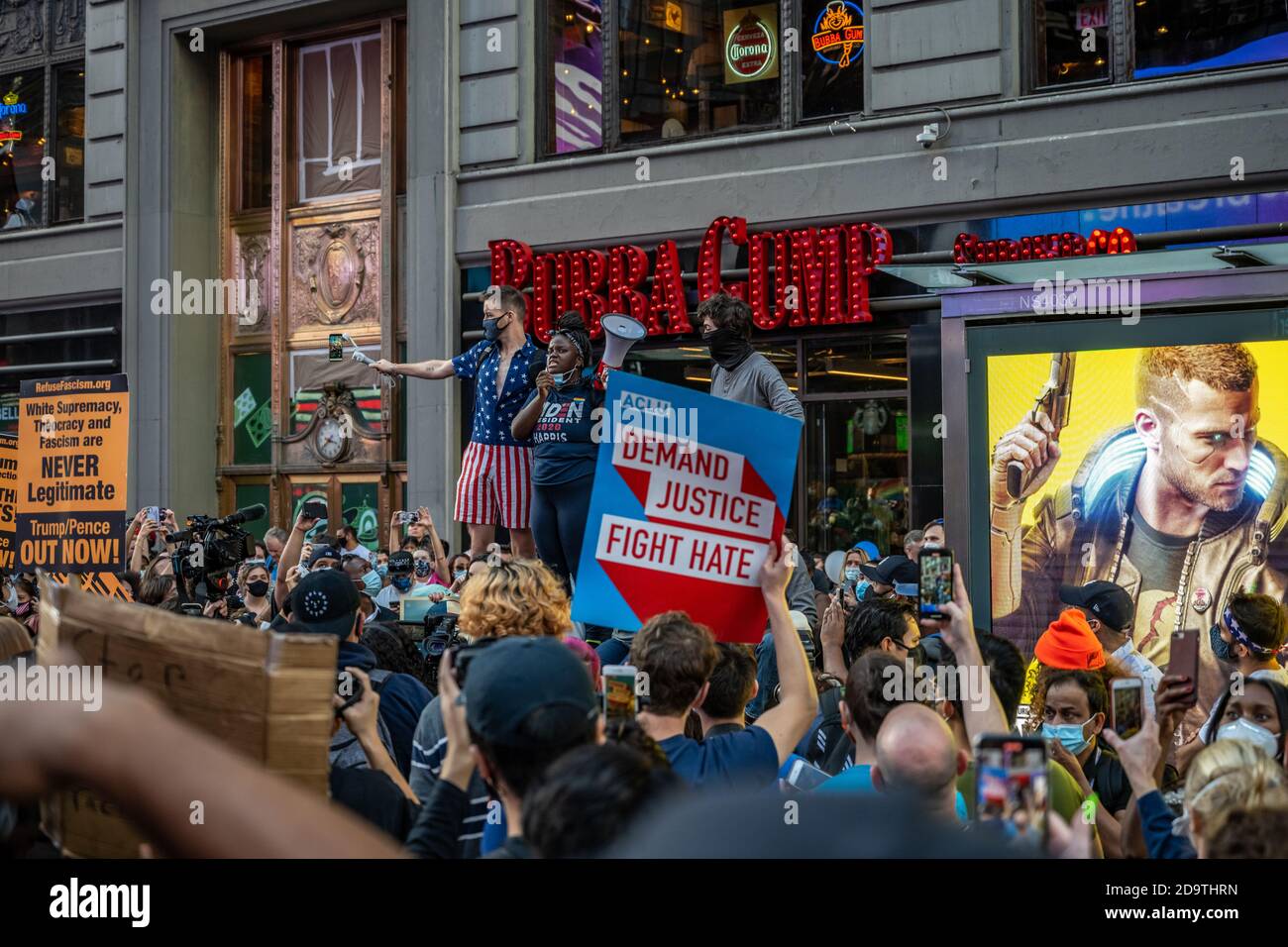 New York, USA. 7th Nov, 2020. People wear face masks as they celebrate in New York City's Times Square after news broke out that former vice-president Joe Biden won the US presidential elections. Biden defeated President Donald Trump to become the 46th president of the United States and Kamala Harris will be the first female vice-president. Credit: Enrique Shore/Alamy Live News Stock Photo