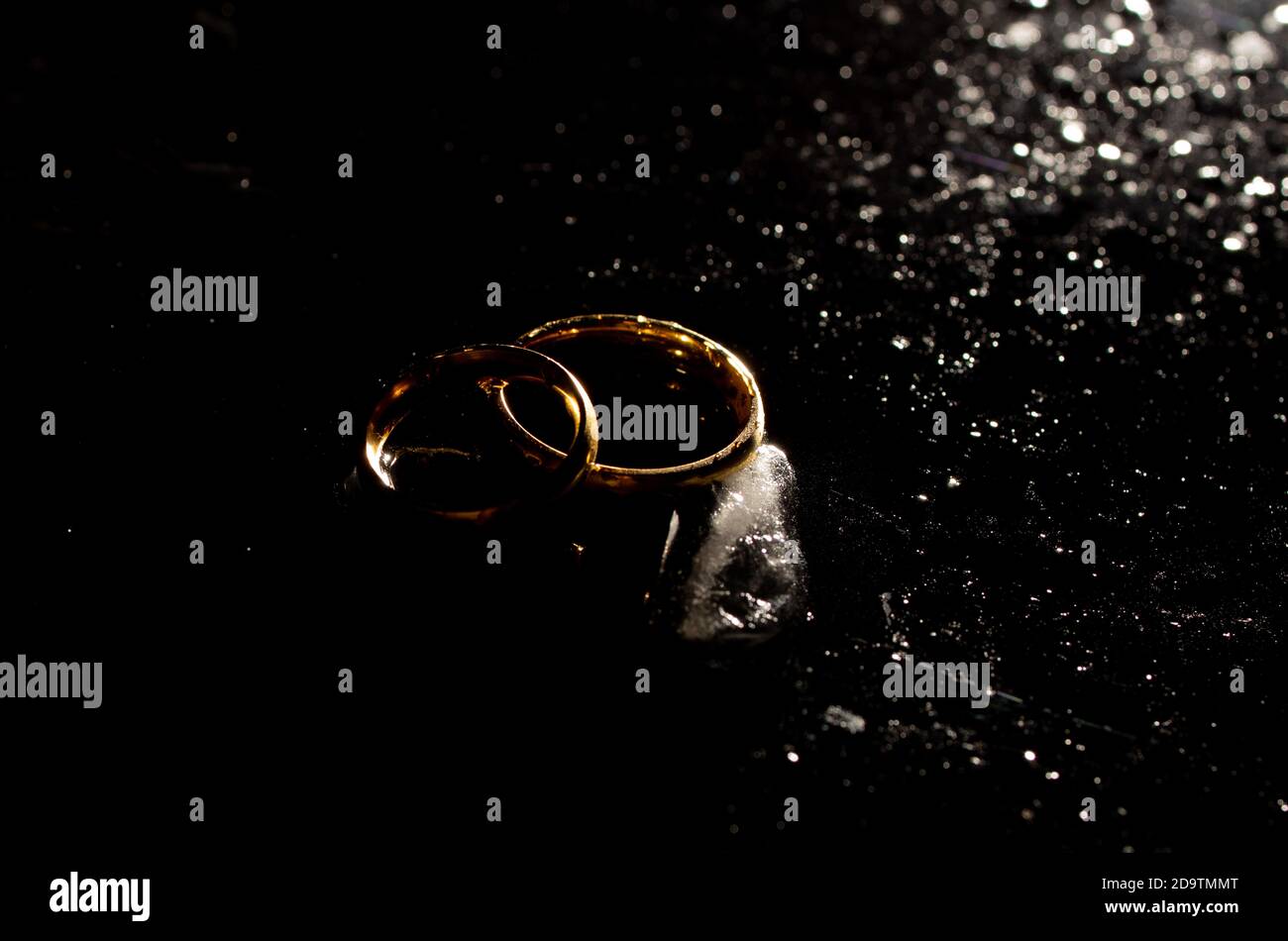 Two golden wedding rings on black background Stock Photo Alamy