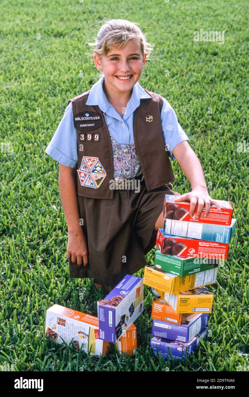 Smiling Young Girl Selling Girl Scout Cookies, USA Stock Photo