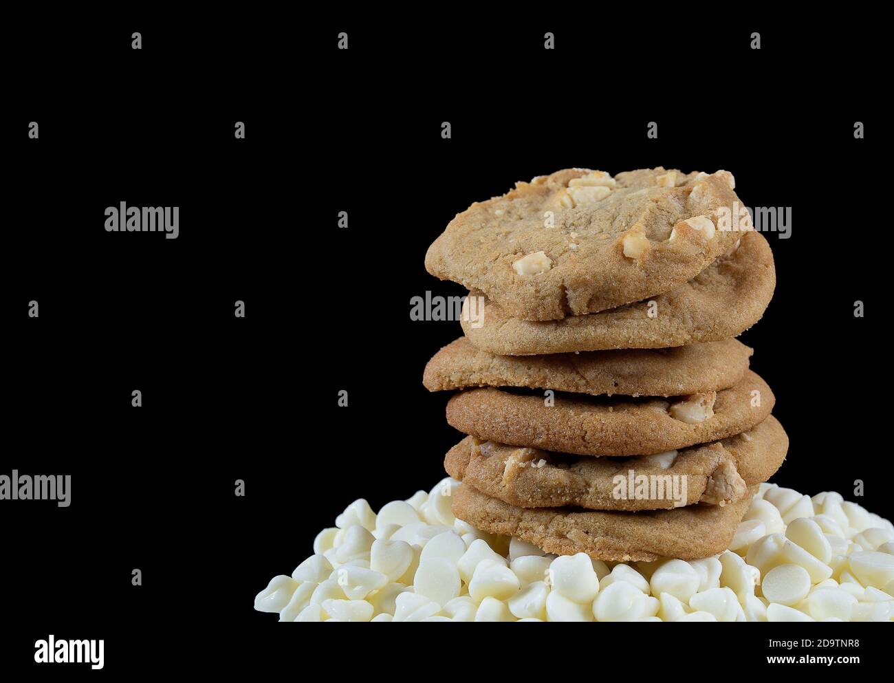 stack of homemade Macadamia nut cookies on white chocolate chips Stock Photo