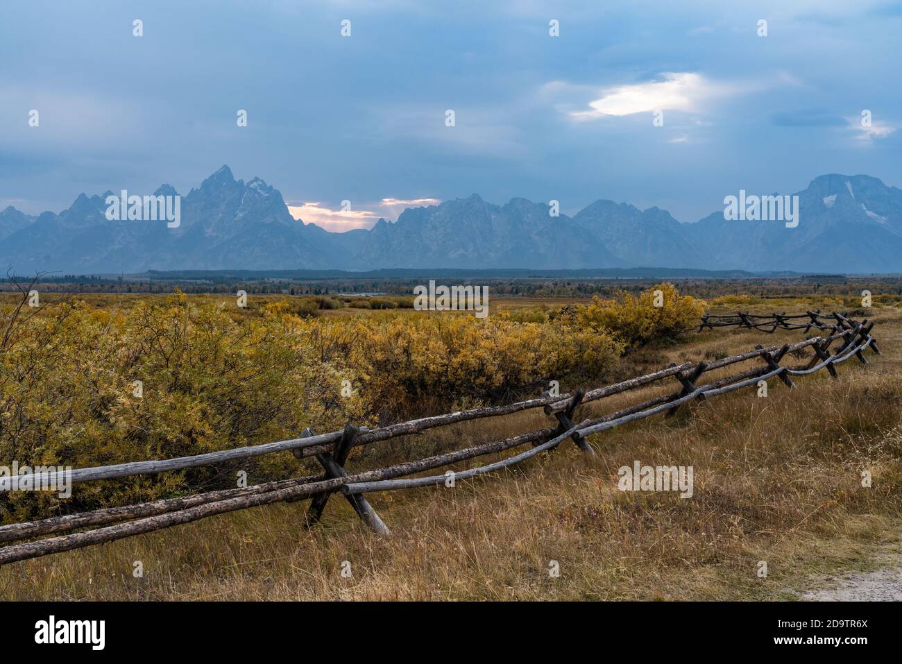 A buck and rail fence near the historic Cunningham cabin with the Teton Range behind  in Grand Teton National Park, Wyoming, USA. Stock Photo