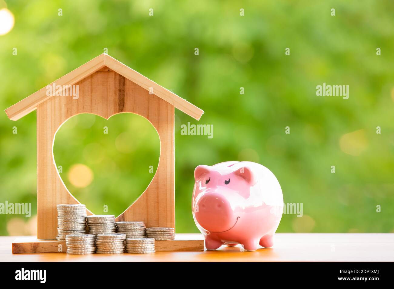 Happy Pink Piggy Bank and Home wooden in close-up and coins stack in ...