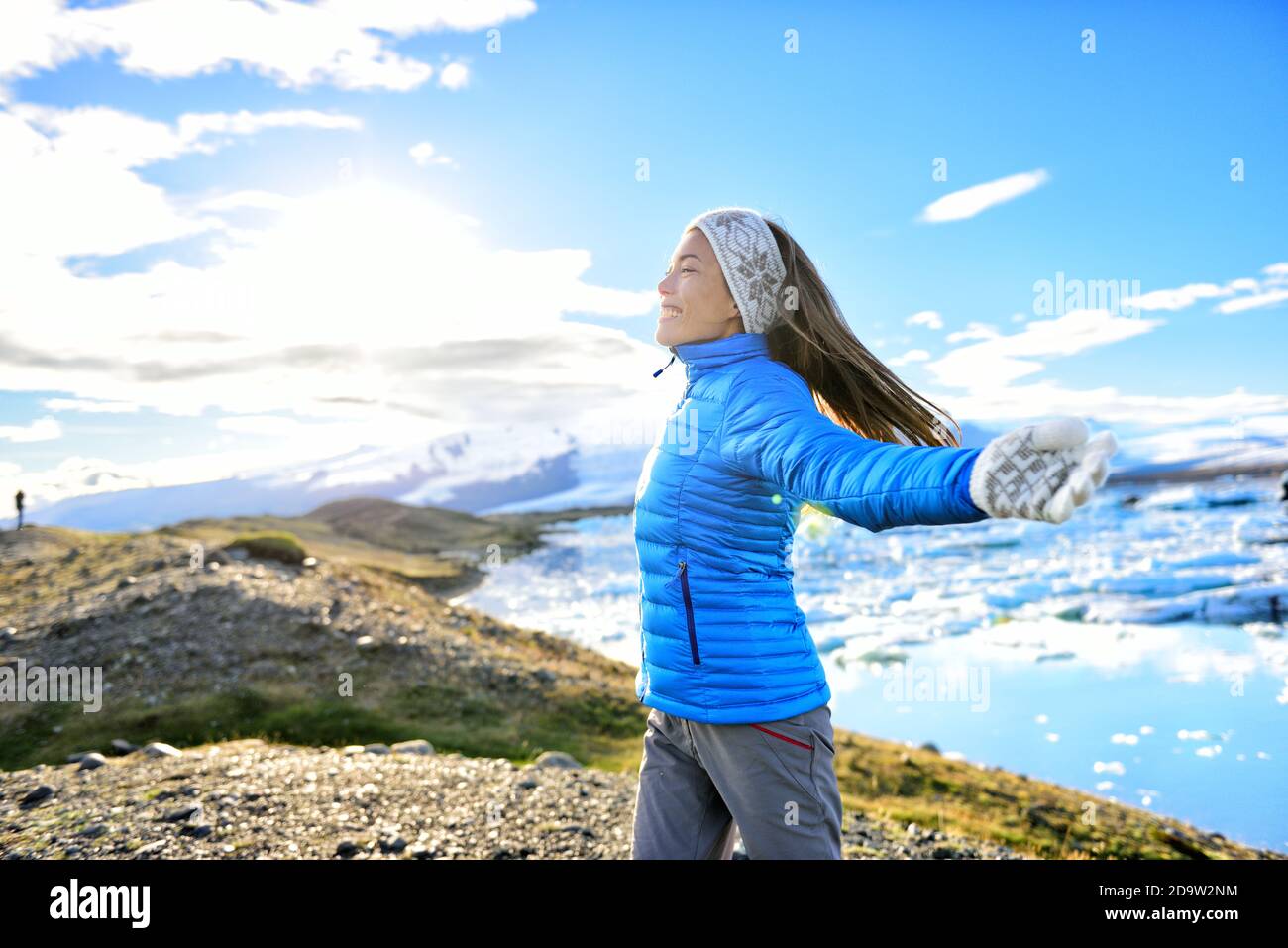 Iceland travel tourist enjoying nature landscape Jokulsarlon glacial lagoon on Iceland. Portrait of Woman standing outdoors by tourist destination Stock Photo