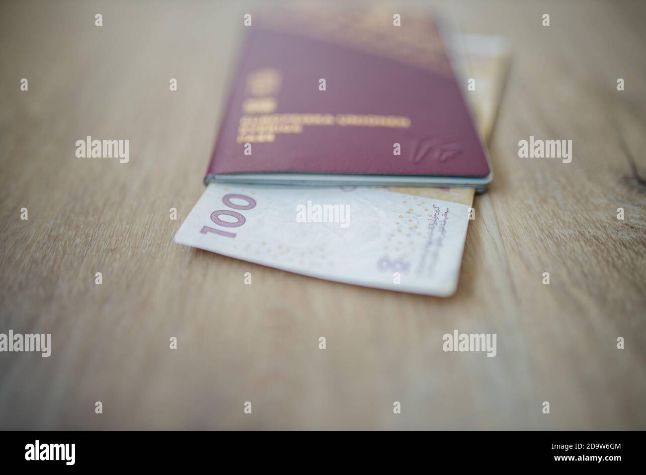 100 Moroccan Dirhams Bill Partially Inside A Sweden Passport Stock 100-moroccan-dirhams-bill-partially-inside-a-sweden-passport-stock