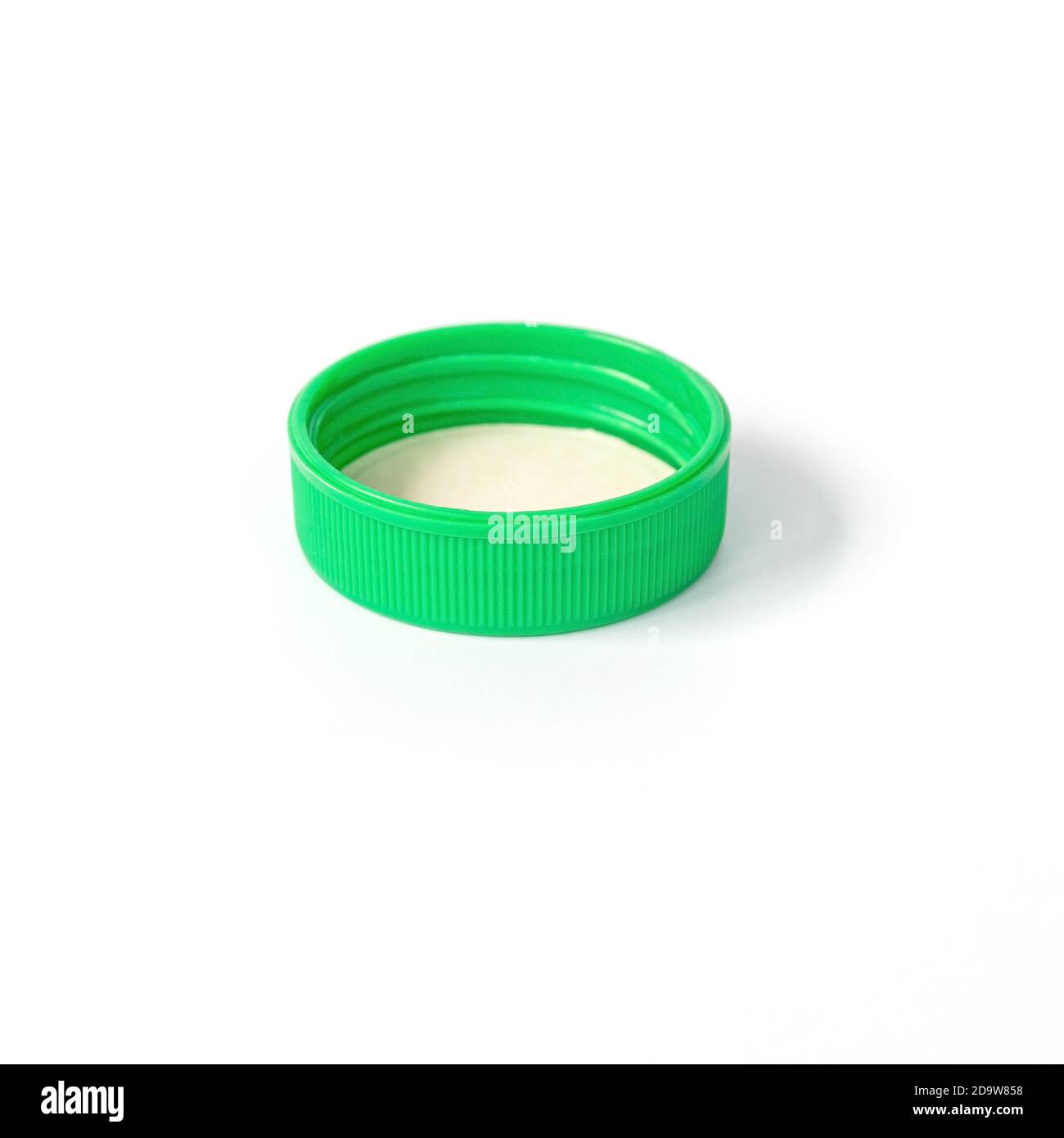 Green plastic bottle cap isolated on white background. Stock Photo