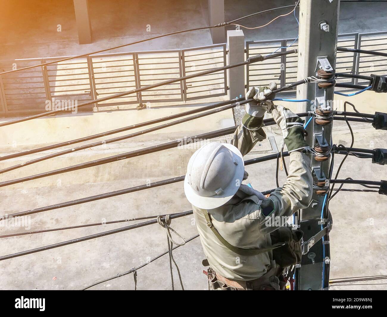 Electricians are climbing on electric poles to install power lines
