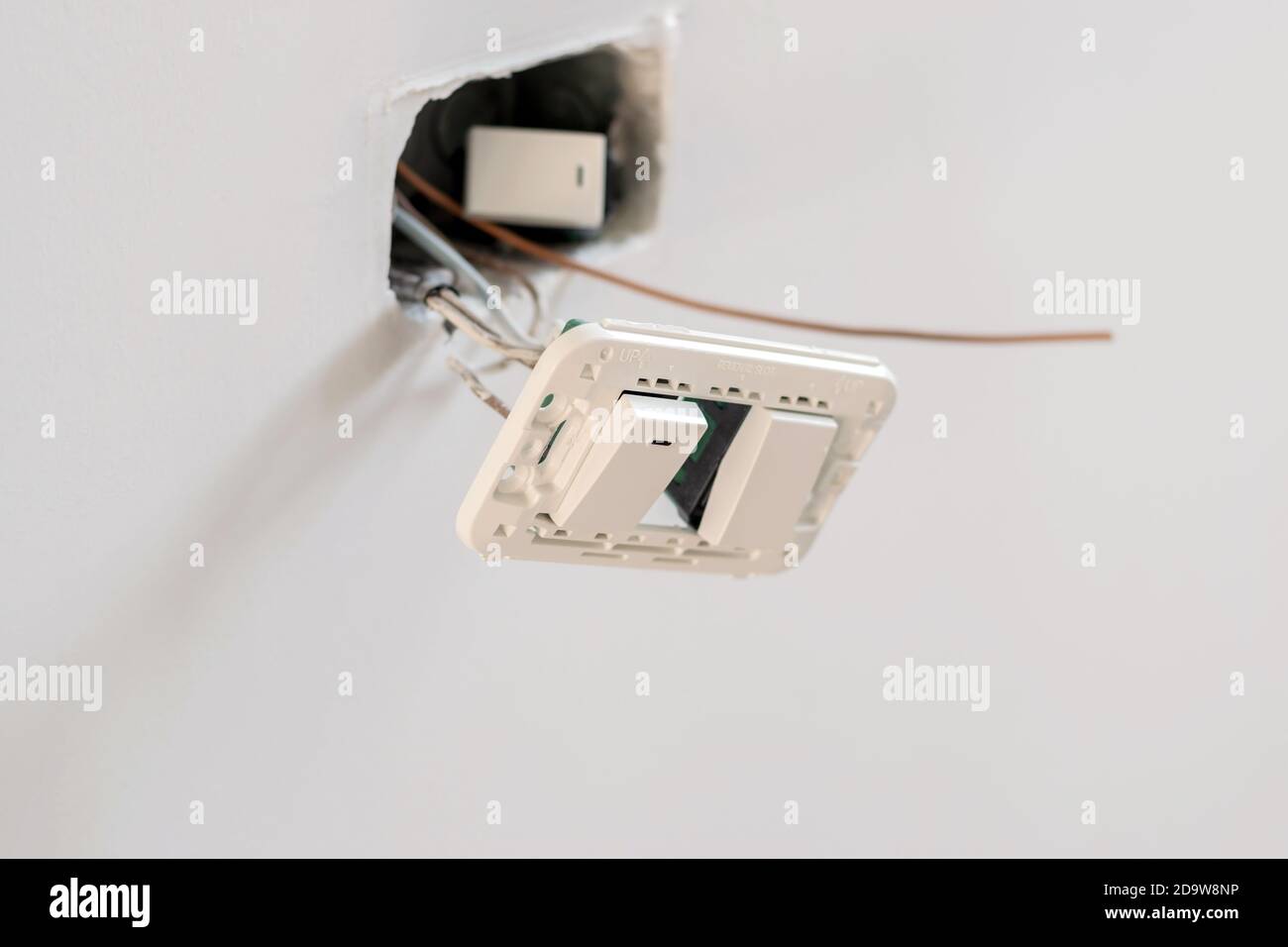 Closeup a white switch for on and off wall lighting for office and ...