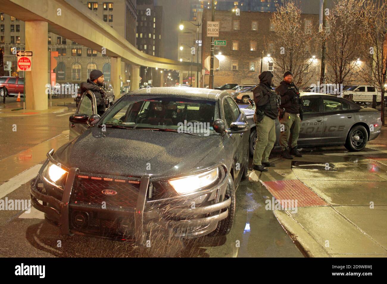 Detroit police officers downtown on a rainy night in Detroit, Michigan, USA Stock Photo