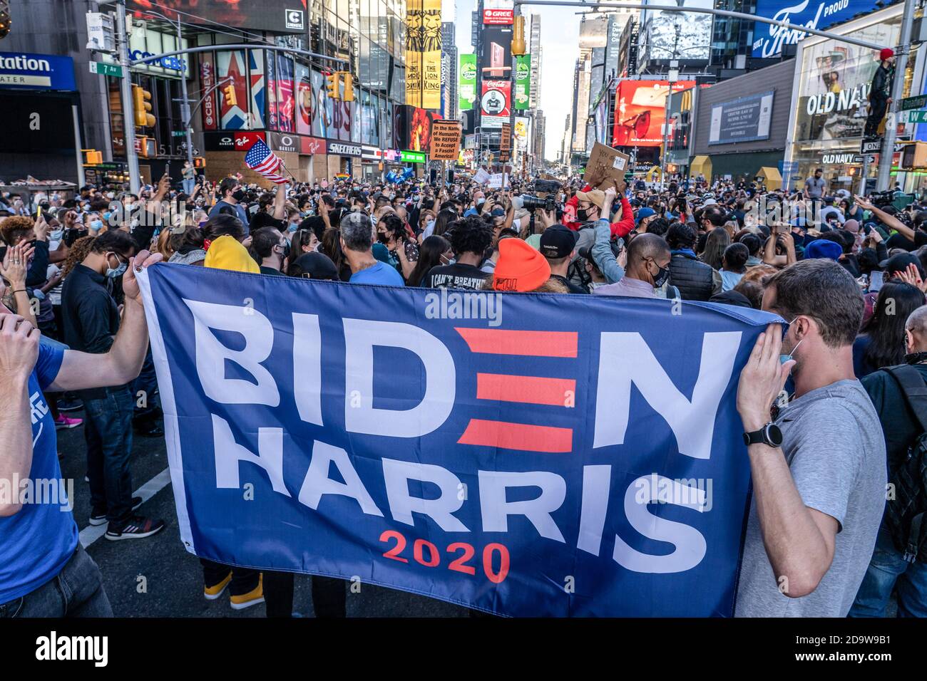 New York, United States. 07th Nov, 2020. People with placards celebrate Biden/Harris ticket election victory in Times Square. People have taken to the streets in droves after several major media outlets called the election for former Vice President Joe Biden. NYPD report there is a range of 500 to 900 people gathered in Times Square. Similar groups gathered in the streets around the city and across the country. Credit: SOPA Images Limited/Alamy Live News Stock Photo