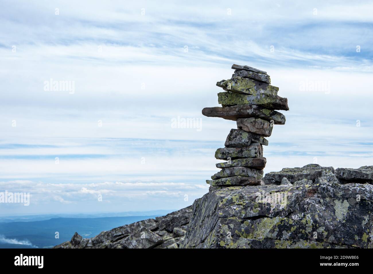 Close-up of stacked pyramid stones that mark a mountain trail, landmark for hiking, symbol of balance. Stock Photo
