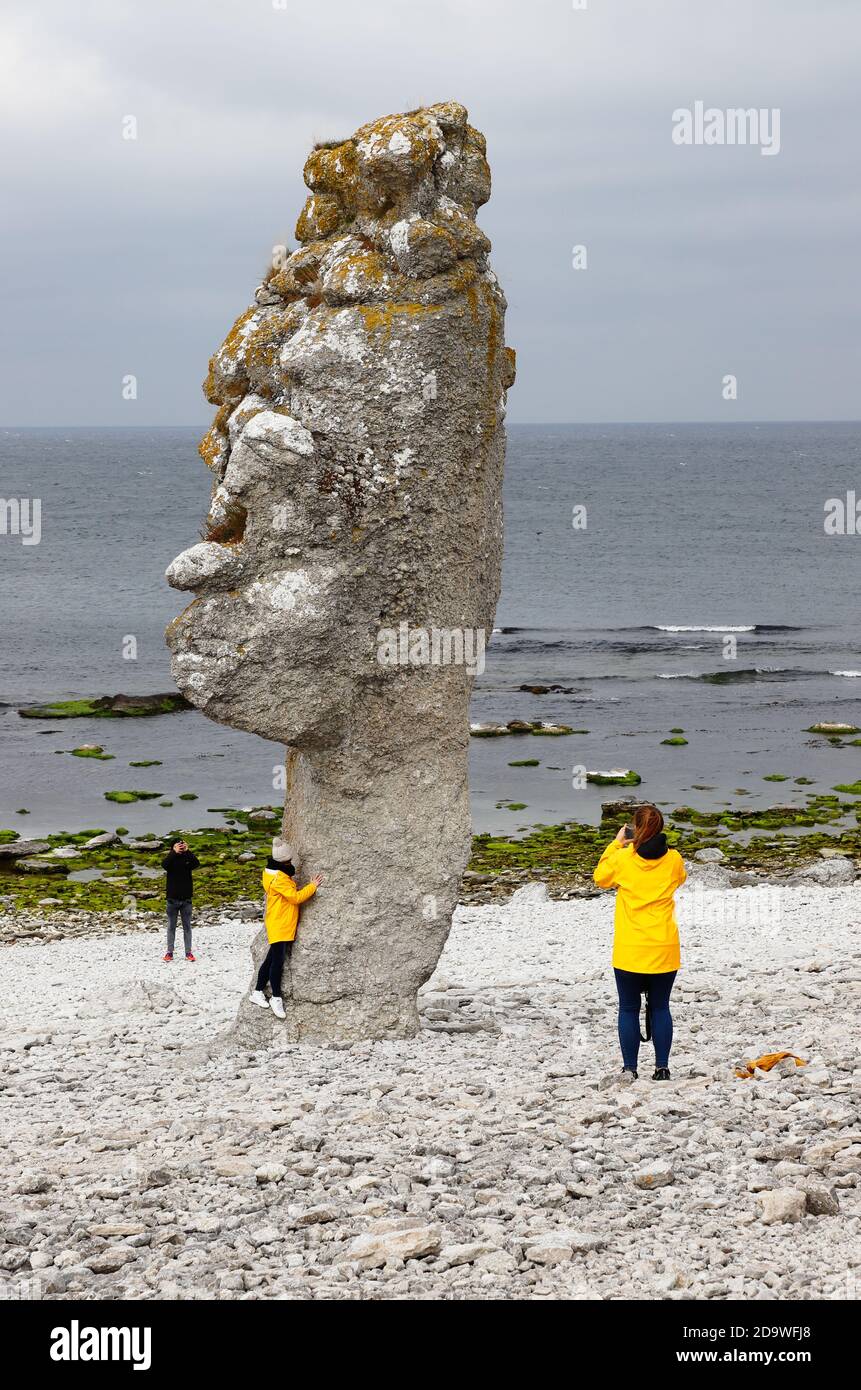Faro, Sweden - October 3, 2020: A group of three people visiting the Langhammar sea stack area. Stock Photo
