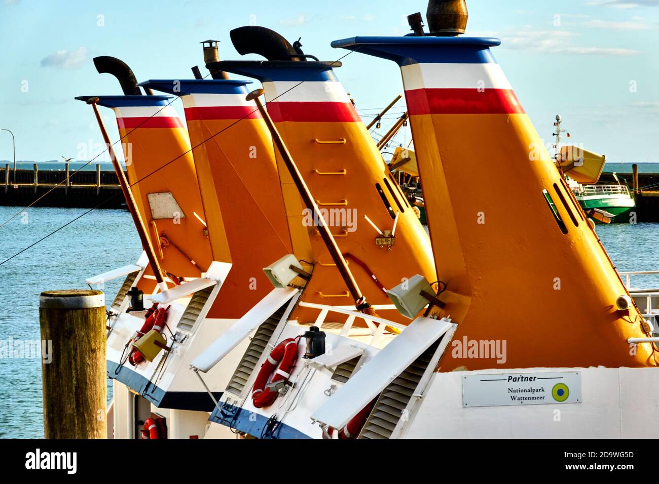 Sylt, Germany, September 4., 2020: Yellow chimneys for the exhaust gases of a passenger ship in the port of Hoernum on Sylt Stock Photo