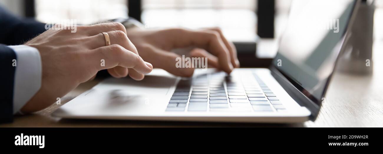 Close up wide banner image young businessman using computer. Stock Photo