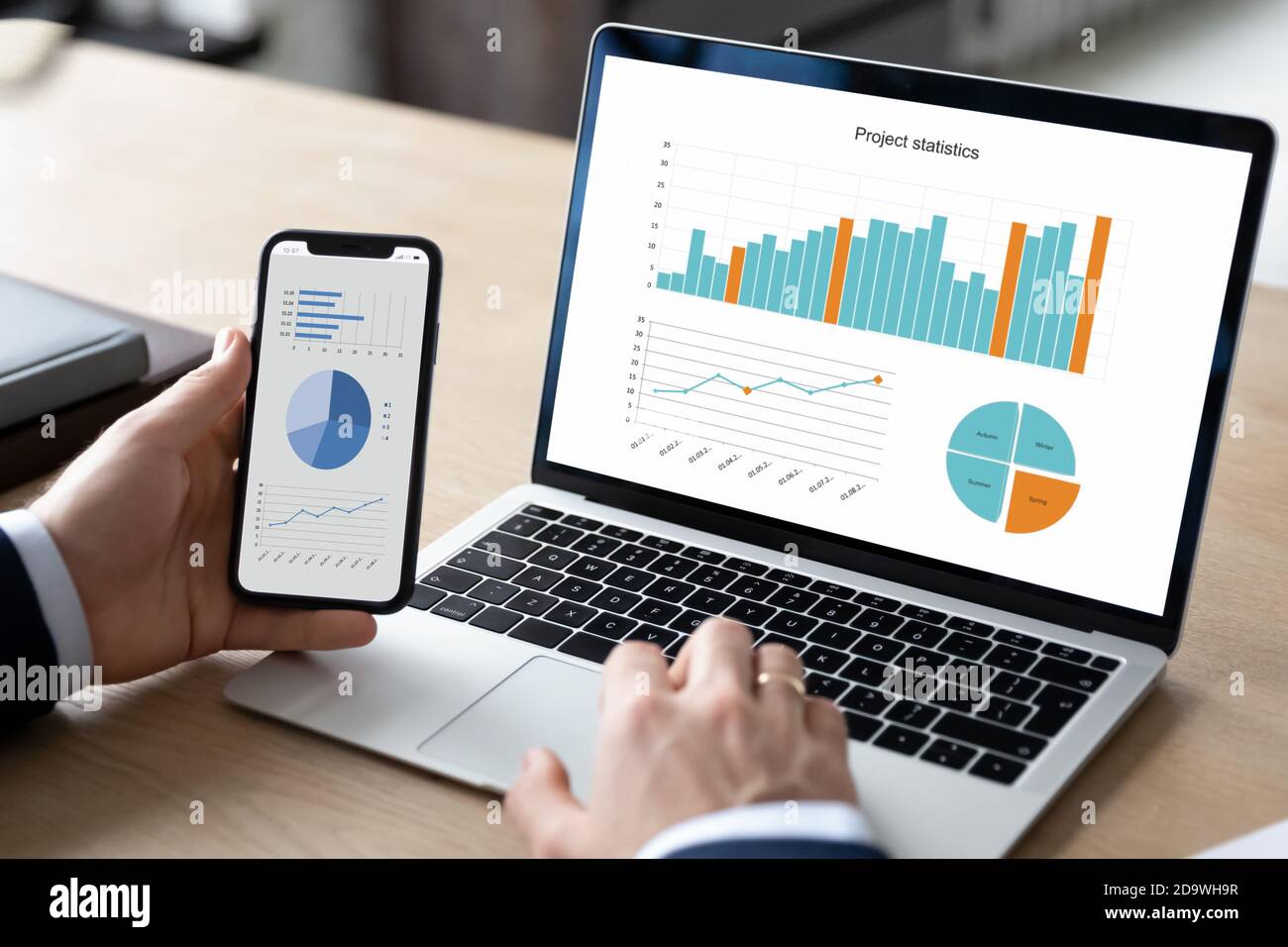 Close up young businessman using modern gadgets, working on project. Stock Photo