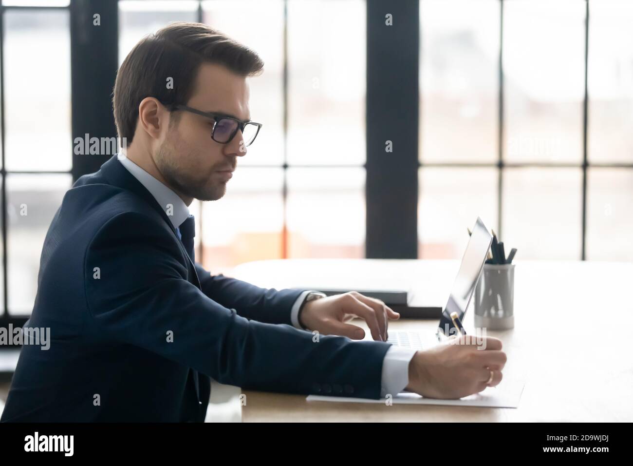 Skilled ceo manager checking financial documentation in office. Stock Photo